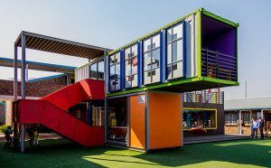 Brilliant in colour and execution. SEED Library II in Alexandra Township, Johannesburg, South Africa, was assembled quickly and inexpensively from recycled shipping containers. Kids are attracted by the building's whimsical appearance. Photo courtesy Andrew Moore/flickr
